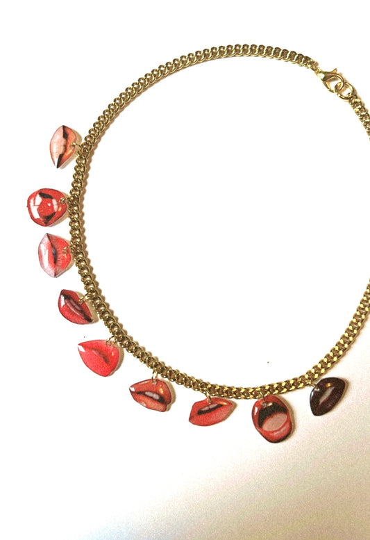 Necklace with lip-shaped pendants on a white background