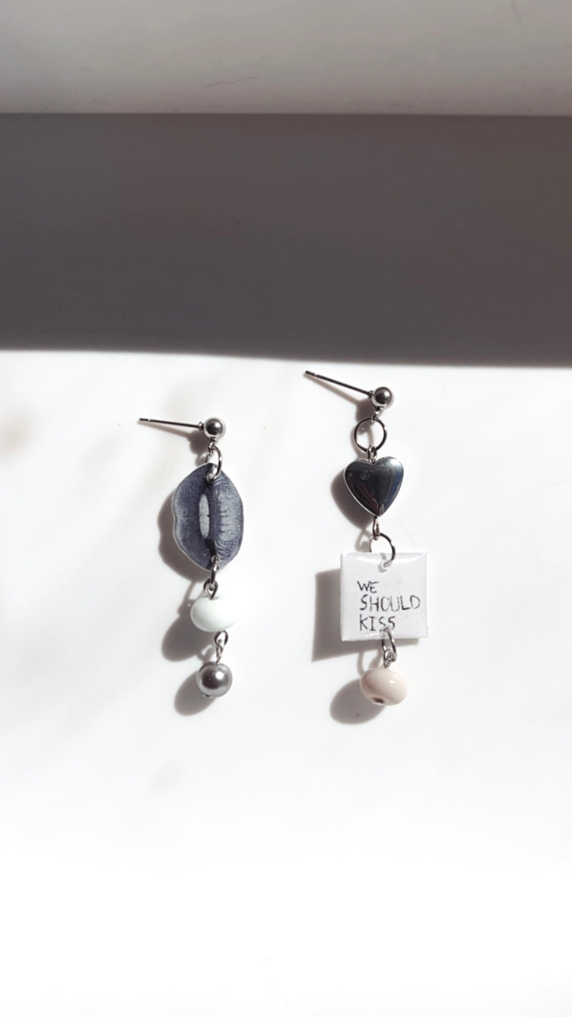 stacked charm dangly earrings. black and white lips, metal beads, stainless steel earrings with charms, stainless steel heart charm earring