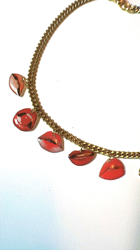 Necklace with lip-shaped pendants on a white background